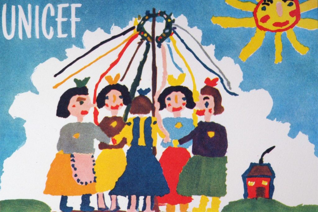 The very first UNICEF Card. A painting by seven-year-old Jitka Samkova of Czechoslovakia shows five girls dancing around a maypole. The word 'UNICEF' appears in the upper-left corner, a sun is in the sky and a small house is in the distance.