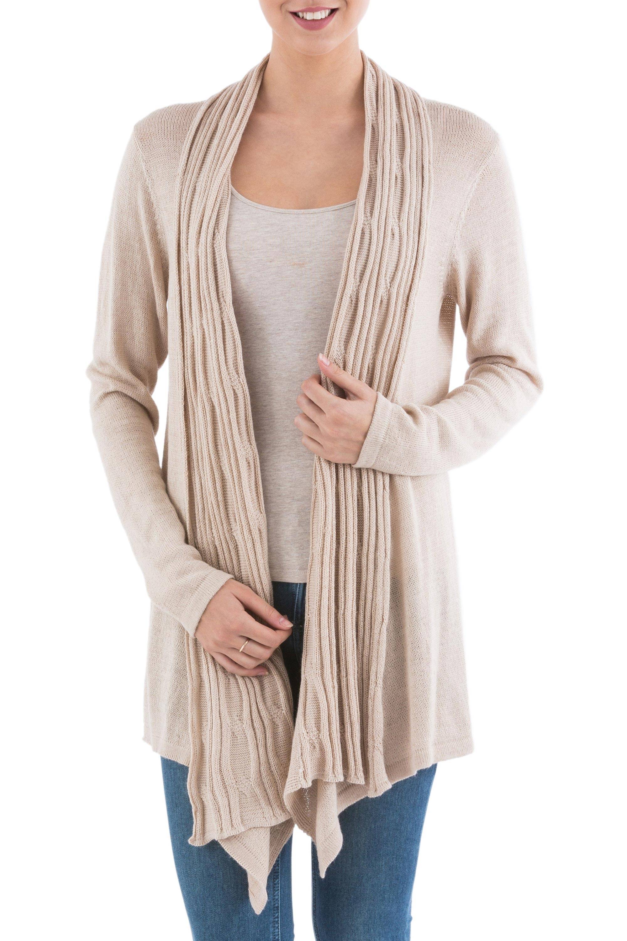  Revamp your wardrobe. Made from a soft blend of acrylic and alpaca wool, the long-sleeved light beige sweater has an open front with an attractive sidetail hem.